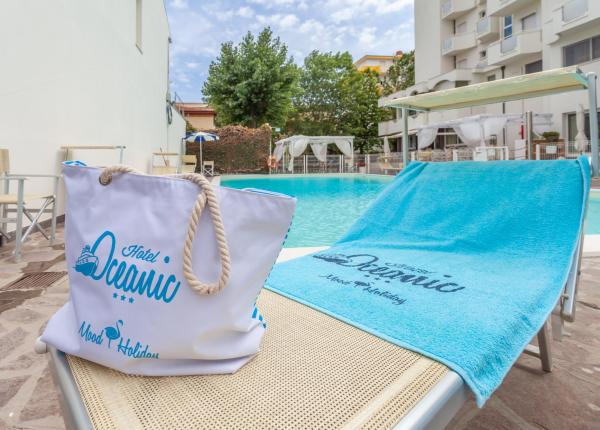 Piscina esterna con lettino e asciugamano dell'Hotel Oceanic.